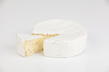Fresh brie cheese with white mold on a white background