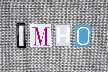 IMHO- In My Humble Opinion acronym cut from newspaper