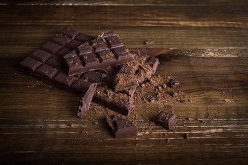 Crushed dark chocolate on a wooden table