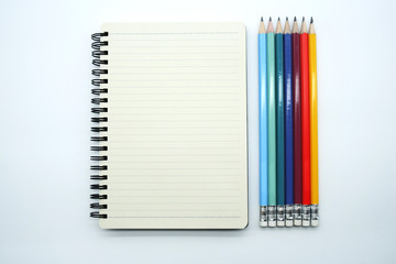 Pencils in various colors and linear notebook