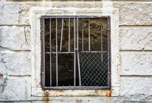 Old wall with barred window