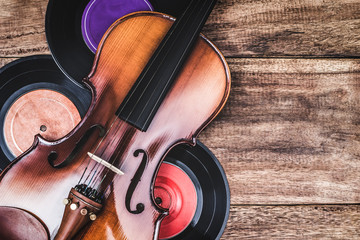 classical violin & records on old wooden table, vintage filter for music background © princeoflove