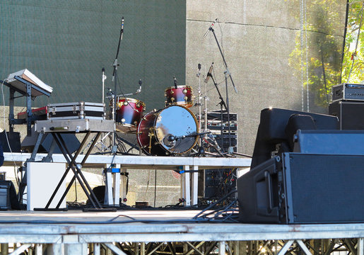 Drum set, microphones and speakers on stage