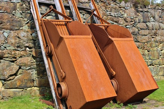 Two old copper tippers next to the copper mine of Visnes on the island Karmoy, Norway, Europe. The mine provided the copper for the Statue of Liberty in New York.