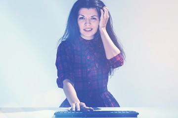 Confused young girl and a keyboard