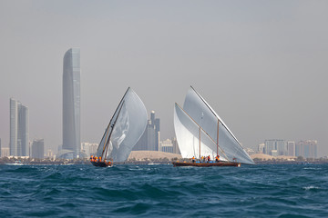 ABU DHABI, UAE - JUNE 7, 2014: Traditional sailing dhows race back to Abu Dhabi at Ghanada Dhow Sailing Race 60 ft. Final Round 