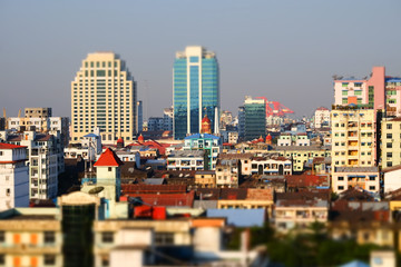 Tilt shift blur effect. Futuristic aerial view panorama of developing Yangon city. Myanmar (Burma)