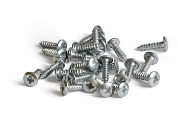 a small pile of screws on white background
