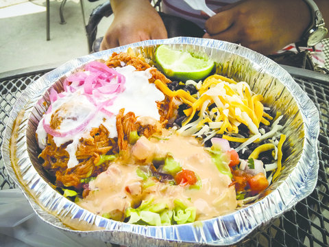 Naked Mexican Burrito with cheese, black beans, sour cream, pulled pork, chiptole and pickled cabbage