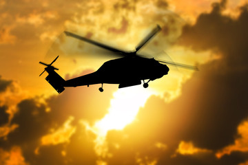 silhouette of helicopter with sunset.