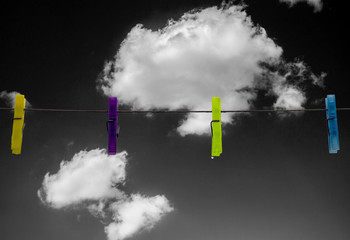 clothes pins on sky background black and white