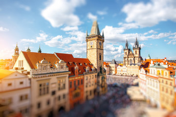 Cityscape view on the clock tower and Tyn cathedral on the old square in Prague.