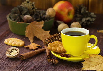 Fototapeta na wymiar Autumn lifestyle with hot tea, sweets, nuts and yellow leaves