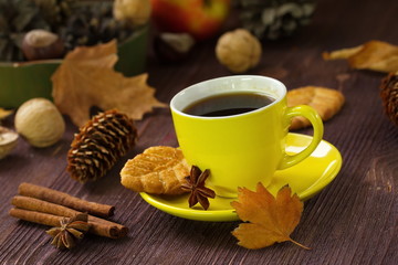 Autumn lifestyle with hot tea, sweets, nuts and yellow leaves