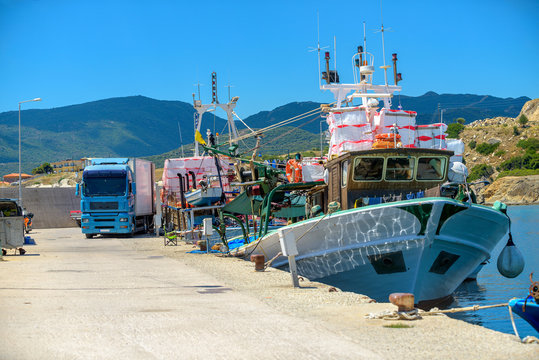 pier with yachts and fishing boats