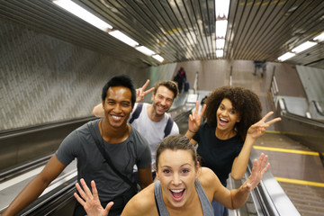 Group of friends having fun in subway stairs
