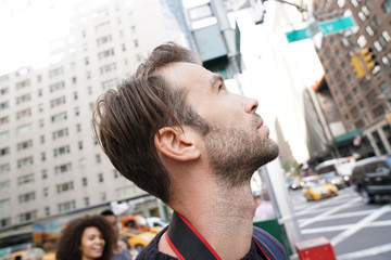 Portrait of man looking at New York city skyscrappers