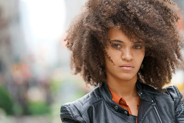 Portrait of mixed-raced girl in town