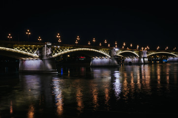 Night view of Margaret bridge nicely illuminated, light reflections in Danube river in Budapest, Hungary