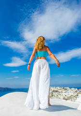 Fototapeta na wymiar WOman on the rooftop in Santorini Greece