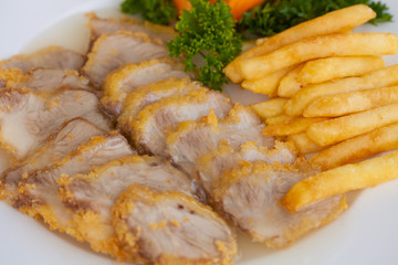 seasoning pork with bread crust serve with fries and vegetable decorate dish