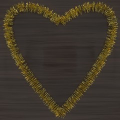 gold tinsel heart on a wood background