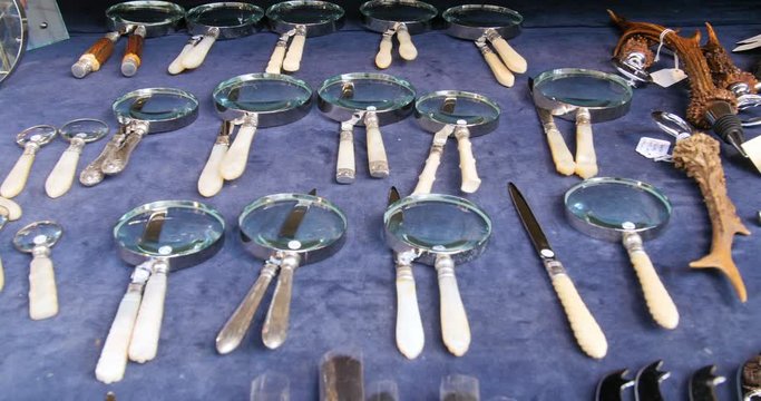 Display of vintage magnifying glasses and razors at famous London Portobello  market