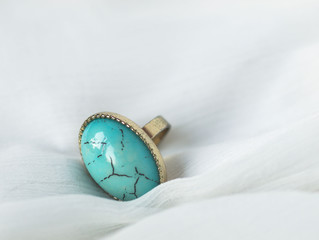 Fashionable turquoise stone ring on white background