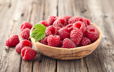 Raspberries in a wooden plate