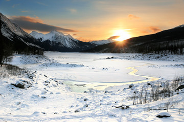 Colorful Sunrise in mountains. Winter Landscape, Rocky Mountains, Alberta, Canada