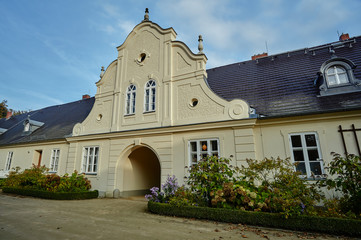 Autumn flowers in front of a historic house in Bad Muskau in Germany.