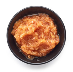 Bowl of apple puree isolated on white background; top view