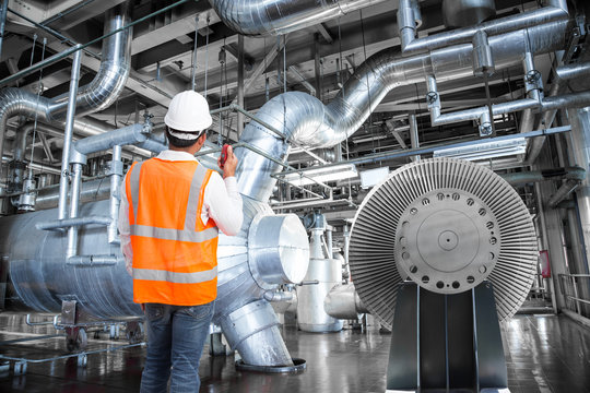 Engineer working in a thermal power plant with radio 