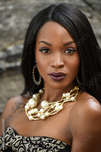 Portrait Of Glamour African American Fashion Model Wearing Dress And Portrait Of Glamour African American Fashion Model Wearing Dress And Jewelry Posing Pretty Outdoors