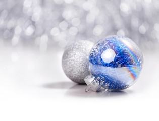 Fototapeta na wymiar Silver and Blue Christmas ornaments balls on glitter bokeh background with space for text. Xmas and Happy New Year theme