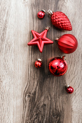 Christmas ornaments and fir tree branch on a rustic wooden background. Xmas card. Happy New Year. Top view with copy space