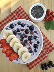 smoothie with yoghurt, decorated with banana and berries