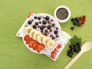 smoothie with yoghurt, decorated with banana and berries