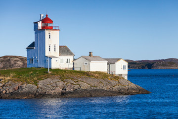 Fototapeta na wymiar Tyrhaug Lighthouse, white tower with red light