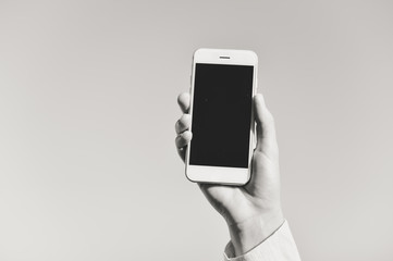 Closeup on smartphone in the hand, copy space background