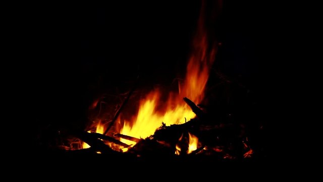 a campfire is burning in the night