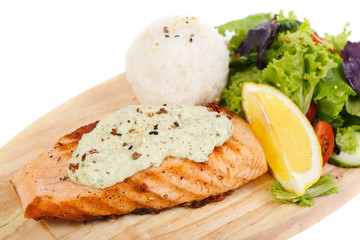 fish steak and Grilled vegetables on cutting board on white back