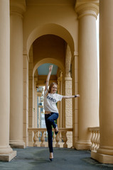 Fototapeta na wymiar Soft focus photo of jumping pretty young girl between columns.