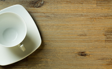 Empty cup on wooden board