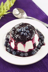 Sweet pudding with blueberry confiture