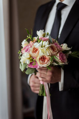 bridal bouquet in hands, wedding bouquet in hands of the groom, groom morning, businessman, wedding, man's fashion, man's style