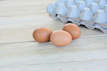 Chicken eggs on a wooden table
