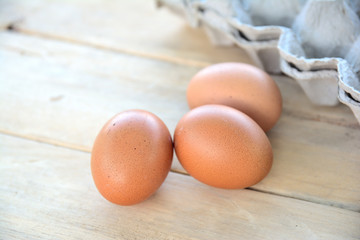 Chicken eggs on a wooden table