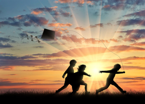 Children sunset play with kite