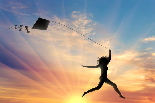 Girl runs sunset with kite